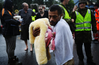 Noel Leon with his three-month-old baby rescued from the flooding hotel.