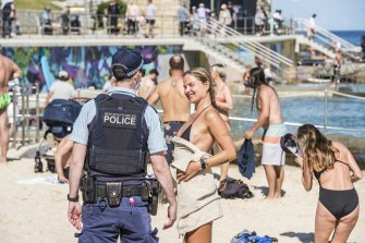 NSW police speak to beachgoers during lockdown on Saturday.