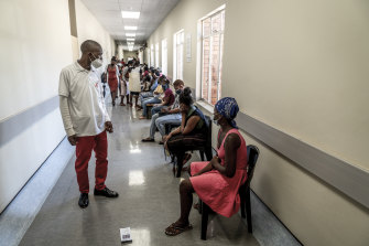 People practice social distancing as they wait to get vaccinated against COVID-19 at the Lenasia South Hospital, near Johannesburg, South Africa.