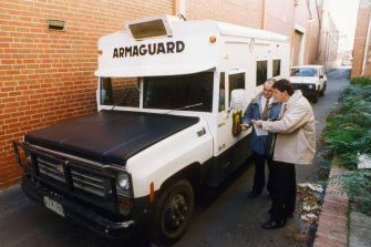 Police examine the Armaguard van after it was abandoned in the Richmond armed robbery in 1994.
