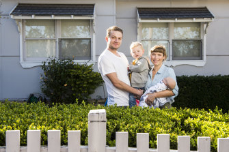 Erin and Andrew Coggins with their son Finn and daughter Luca outside their North Parramatta home.