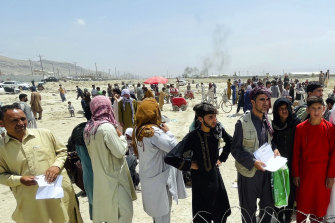 Hundreds of people gather outside the international airport in Kabul, Afghanistan.