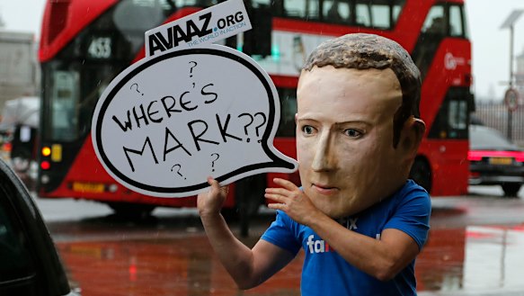 An activist wearing a Mark Zuckerberg mask stands outside the British parliamentary meeting in Westminster last year.