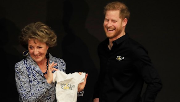 Princess Margriet of the Netherlands presents Britain's Prince Harry with an outfit for his newborn son at the launch of the 2020 Invictus Games, in The Hague, Netherlands, Thursday, May 9, 2019. 