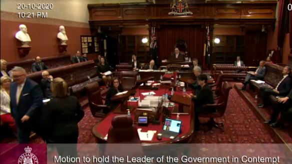 Don Harwin being escorted out of the NSW Legislative Council on Tuesday night.