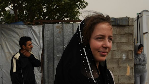 Syrian refugee Nermin Alwan in front of her home in Basirma camp where she lives with her four sisters, brother and parents.