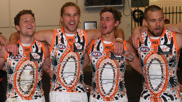 Sing when you're winning: GWS celebrate their Indigenous Round win over the Demons in Melbourne.
