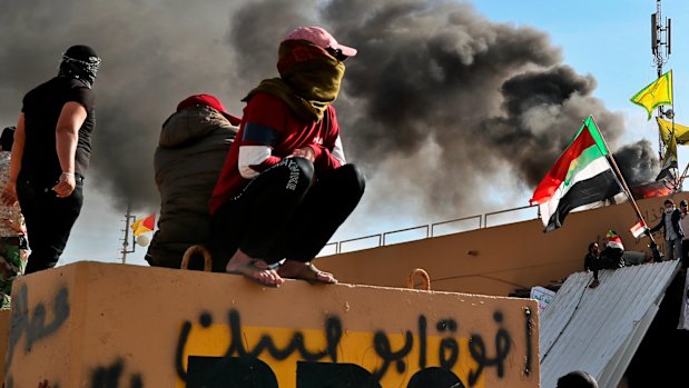 Pro-Iran militiamen and other protesters outside the US embassy compound in Baghdad.