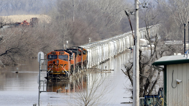 A train sits in flood waters from the Platte River, in Plattsmouth, Nebraska, on Sunday.