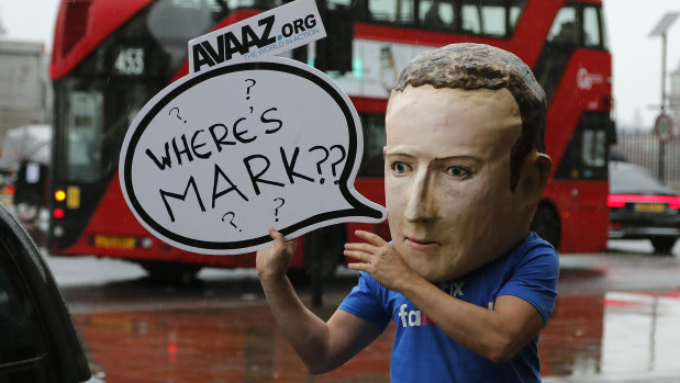 An activist wearing a Mark Zuckerberg mask stands outside the British parliamentary meeting in Westminster last year.