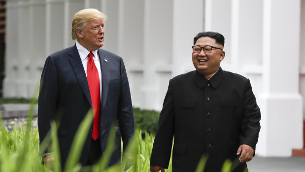 Donald Trump and Kim Jong-un walk together after lunch.