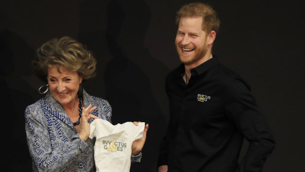 Princess Margriet of the Netherlands presents Britain's Prince Harry with an outfit for his newborn son at the launch of the 2020 Invictus Games, in The Hague, Netherlands, Thursday, May 9, 2019. 