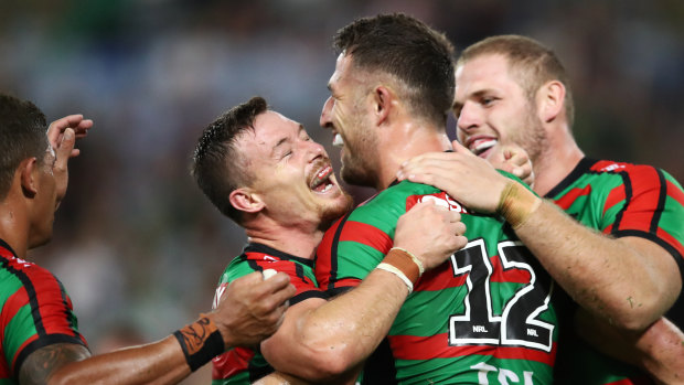 The rock: The Bunnies gather around Sam Burgess after he scored against Brisbane.