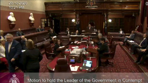 Don Harwin being escorted out of the NSW Legislative Council on Tuesday night.