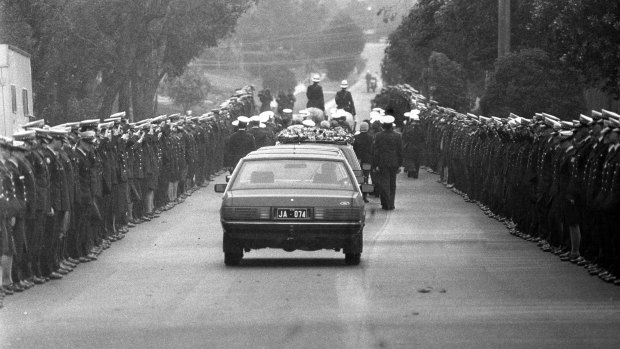 A police guard lines View Mount Road as the cortege leaves for Springvale cemetery.