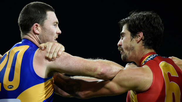 Push and shove: Eagle Jeremy McGovern clashes with the Suns' Alex Sexton during the round 2 match at Metricon Stadium on the Gold Coast.