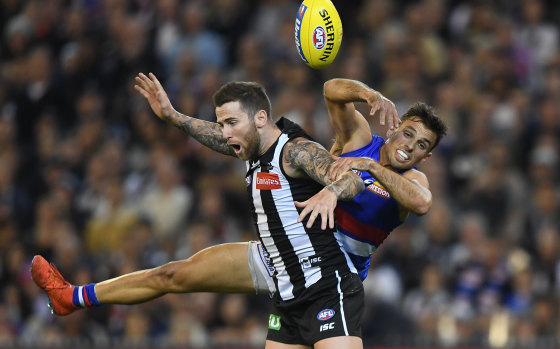 Jeremy Howe of the Magpies and and Sam Lloyd of the Bulldogs contest the ball at the MCG on Friday night.