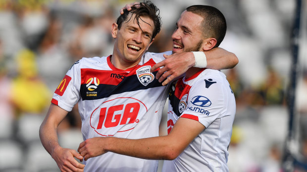 Top form: Craig Goodwin (left) celebrates an Adelaide goal with Apostolos Stamatelopoulos.