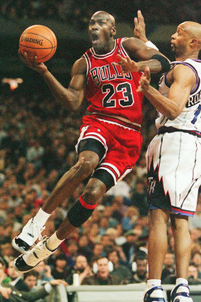 Michael Jordan takes flight against Toronto's Alvin Robertson in 1996.