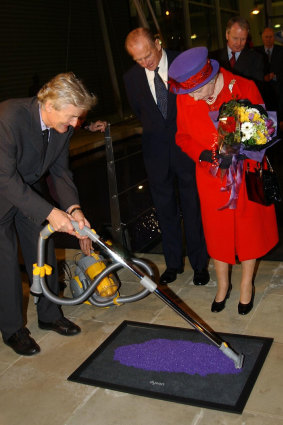 The Queen and the Duke of Edinburgh watch James Dyson unveil a plaque at the vacuum cleaner maker's factory,  2001. 
