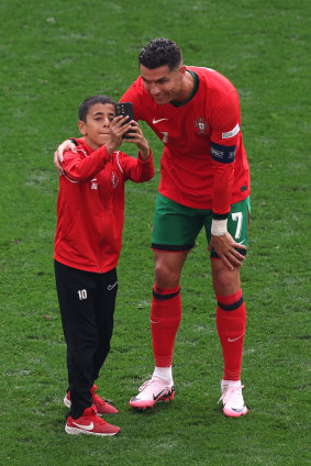 Ronaldo takes a selfie with a young fan.