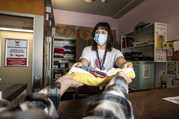 Wayside Chapel employee Gabi hands out bathroom sets as the cost of living crisis bites.