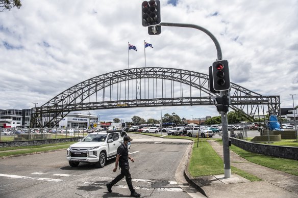 A replica harbour bridge spans the entrance to the Peter Warren Automotive car yards in Warwick Farm.