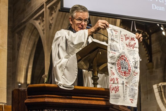The Dean, Sandy Grant, showing the congregation of St Andrew’s Cathedral a coronation tea towel he bought in London.