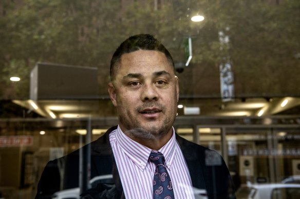 Jarryd Hayne exits the glass doors of the District Court during his trial.