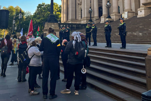 Protesters on the steps of Parliament House on Monday morning.