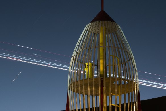 Rocket play equipment in Enmore Park with time-lapse lights from landing aircraft. 