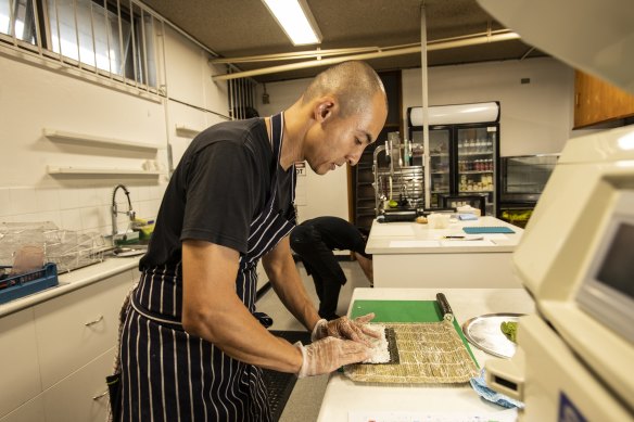 Kenji Okuda preparing lunch orders for students at Stanmore Public School.