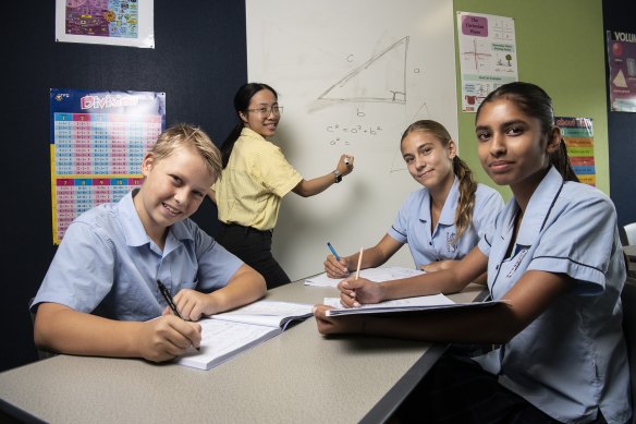 Glenwood High School year 8 maths class students Nathan Hobby, Halle Conyard and Yubi Gara being taught by Carmen Cheung.