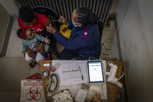 A woman is vaccinated against COVID-19 at the Hillbrow Clinic in Johannesburg, South Africa.
