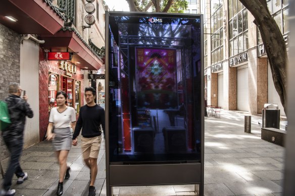 A billboard in the middle of the al fresco dining destination of Dixon Street in Chinatown.