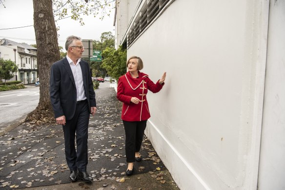Glebe resident Ash Wood and City of Sydney councillor Linda Scott inspect a wall that had been daubed with hate-speech graffiti.