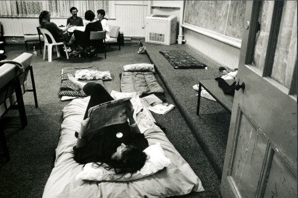 Yolanda Crawley (who is parent of a student) reads a paper late at night at the sit-in at Fitzroy Secondary College which is to be closed.