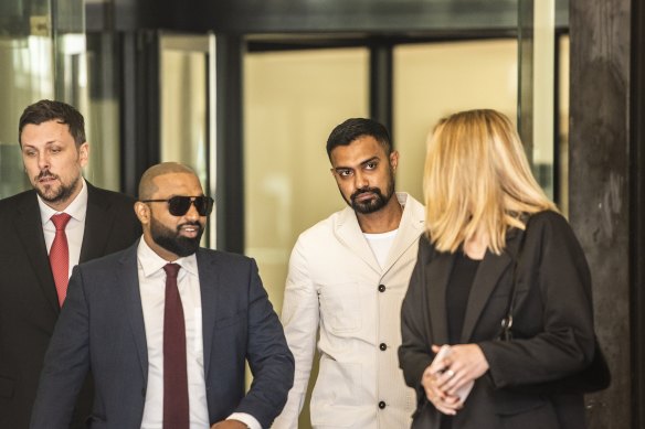 Danushka Gunathilaka (second from right) leaving the Downing Centre on Wednesday.