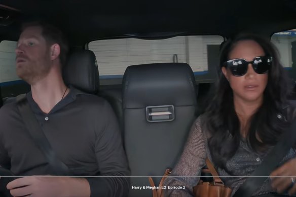 Harry and Meghan dodge paparazzi in this screenshot from the Netflix documentary Harry & Meghan.