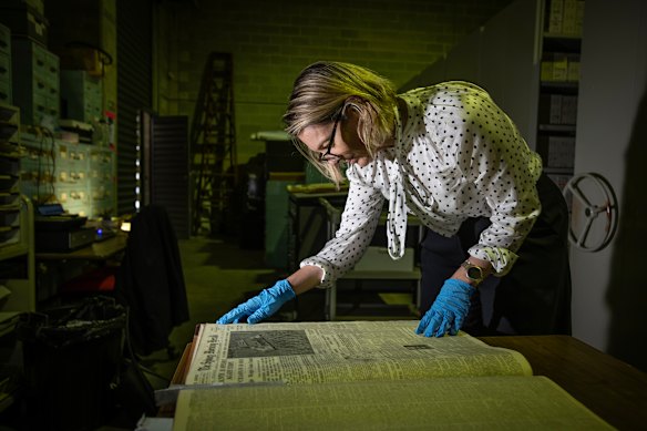 Sydney Morning Herald editor Jordan Baker looking at old editions in the Fairfax archives.