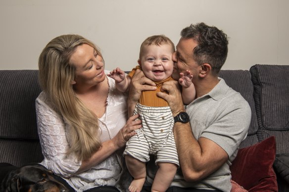 Allie Richards and husband John with 10-month-old Charlie, whose older brother Lenny was stillborn in February 2021.