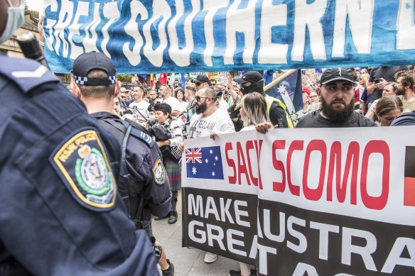 Protesters carrying signs at the front of the rally in Sydney