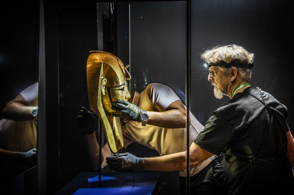 The Gold Gilded mask from the coffin of Pharaoh Amenemope is installed at the Australian Museum.
