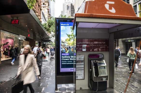 Some of the billboards are located right next to phone booths, largely obscuring one side from view.