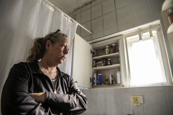 Angela Sharp holds her breath when using her bathroom at her public housing unit in Waverly to avoid breathing in mould spores.