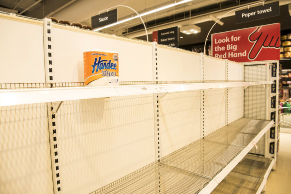 Empty toilet paper shelves at Coles.