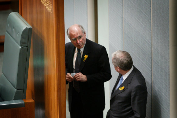 John Howard talks to then Labor leader Simon Crean in the House of Representatives in August 2003. Days later, Howard would convince his cabinet to dump support for an emissions trading scheme.