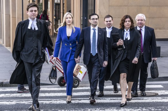 Surgeon Munjed Al Muderis, his partner Claudia Roberts and his legal team outside the Federal Court in Sydney on September 4.