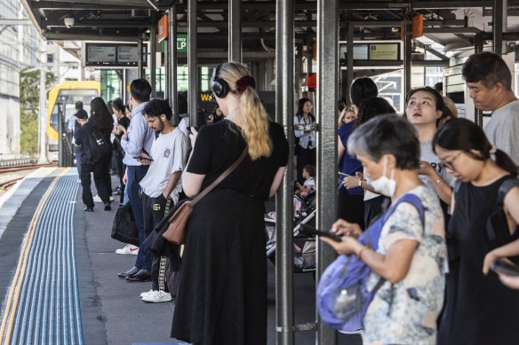 Commuters wait for delayed trains at Burwood station on Wednesday morning.