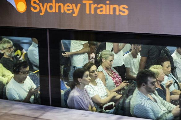 Glum commuters wait aboard a train parked at Chatswood Station. 